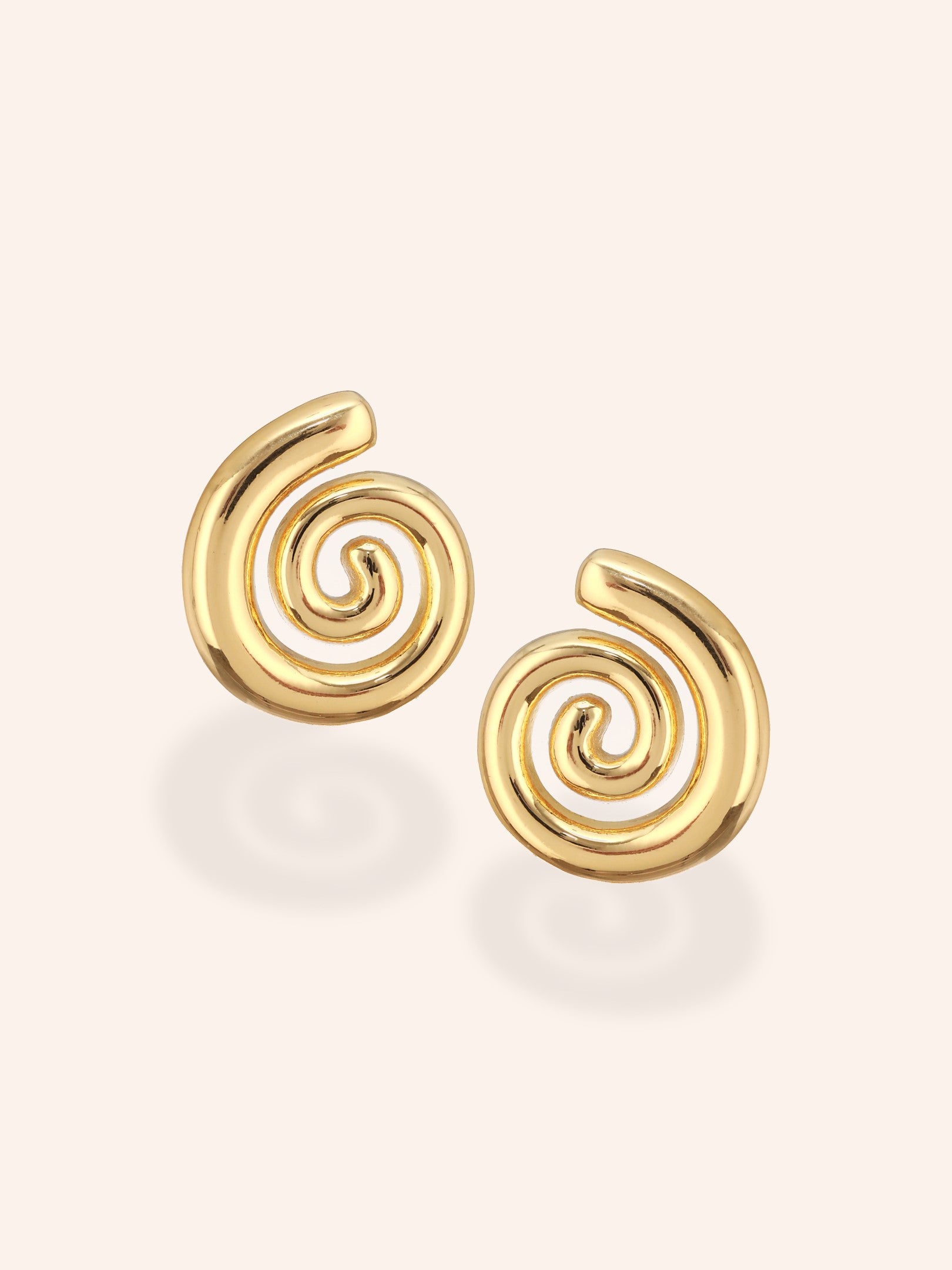 Displayed on a white backdrop, The Swirl Studs of Zelci shine with elegance