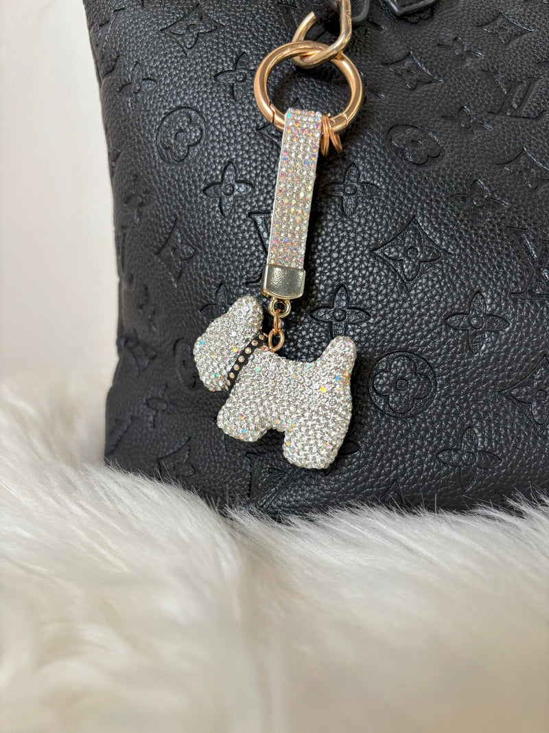 Glam Pup Keychain of Zelci with dog charm attached to a black textured bag