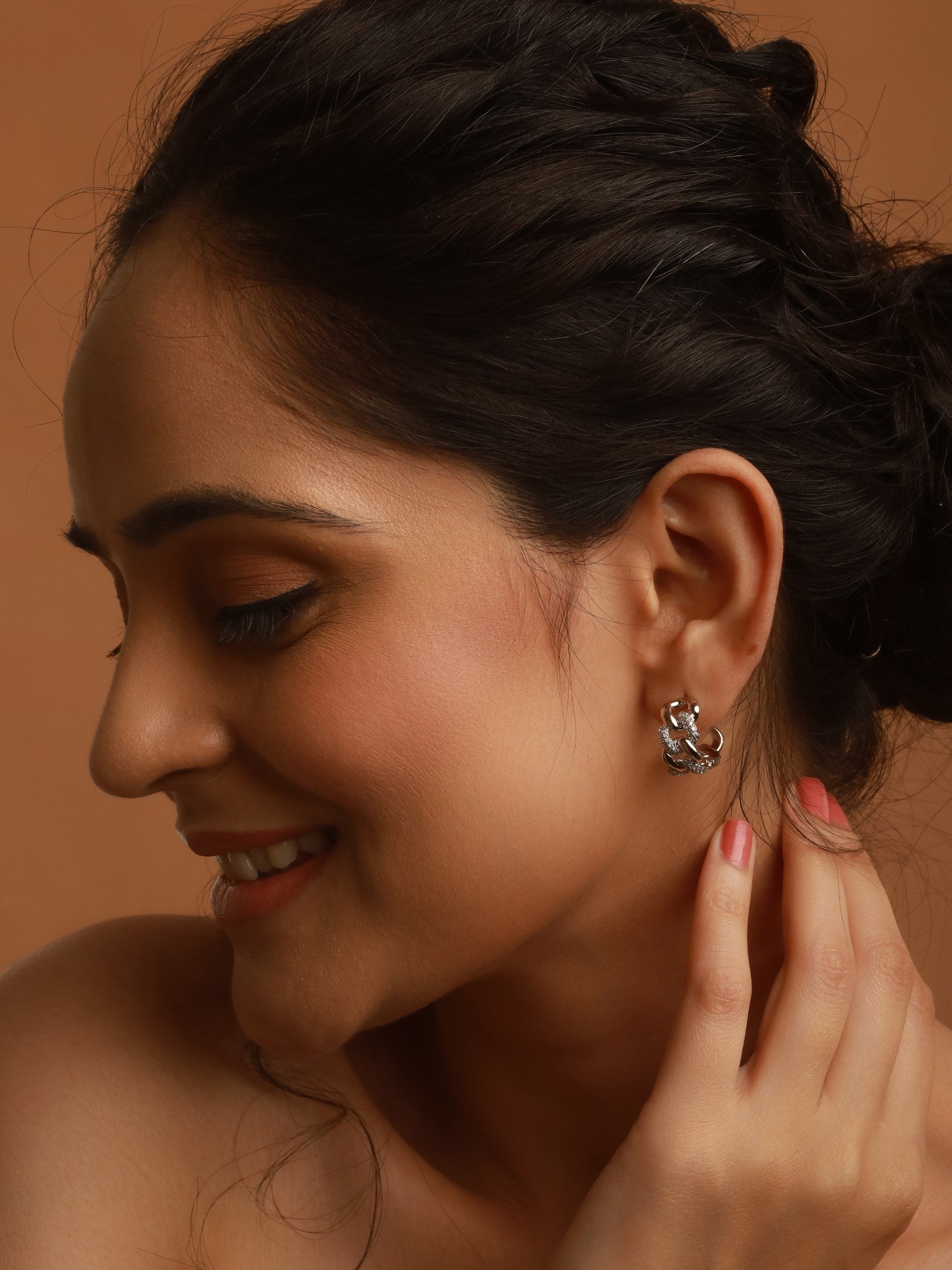 The model in smilling face is posing with Chain Link Studs of Zelci