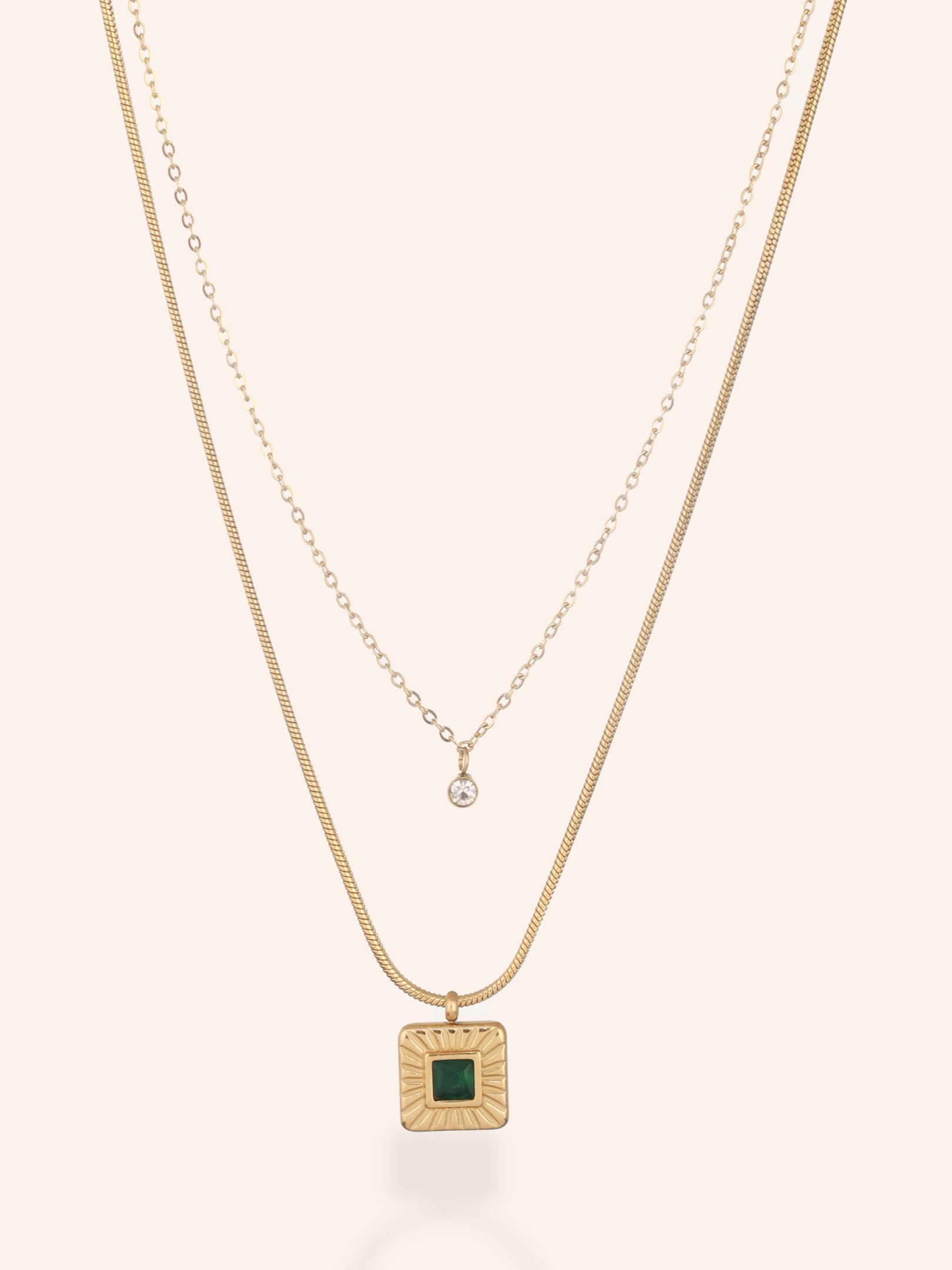 Zelci's Emerald Radiance Necklace is shown on a light backdrop