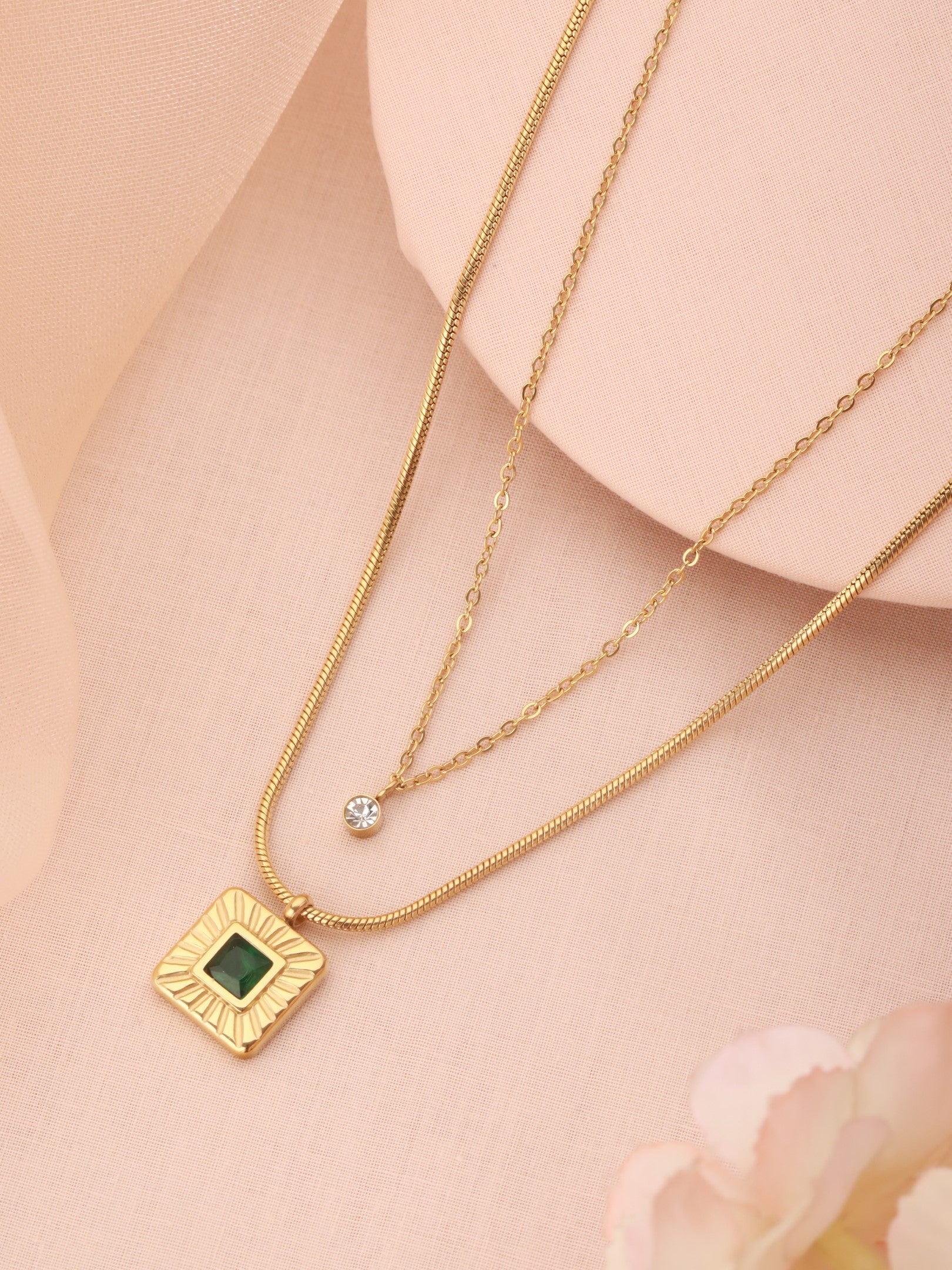 Zelci’s Emerald Radiance Necklace is shown against a stunning backdrop