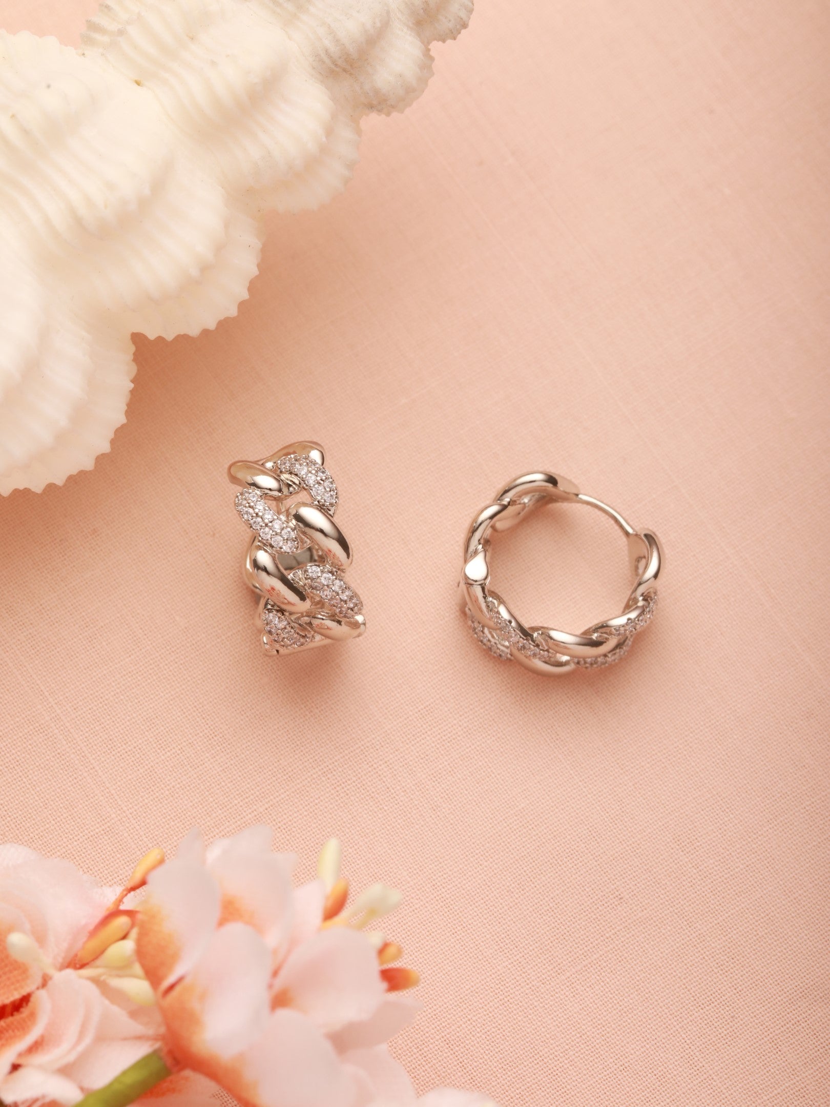 Zelci’s Chain Link Studs stands out vividly on a beautifully designed surface