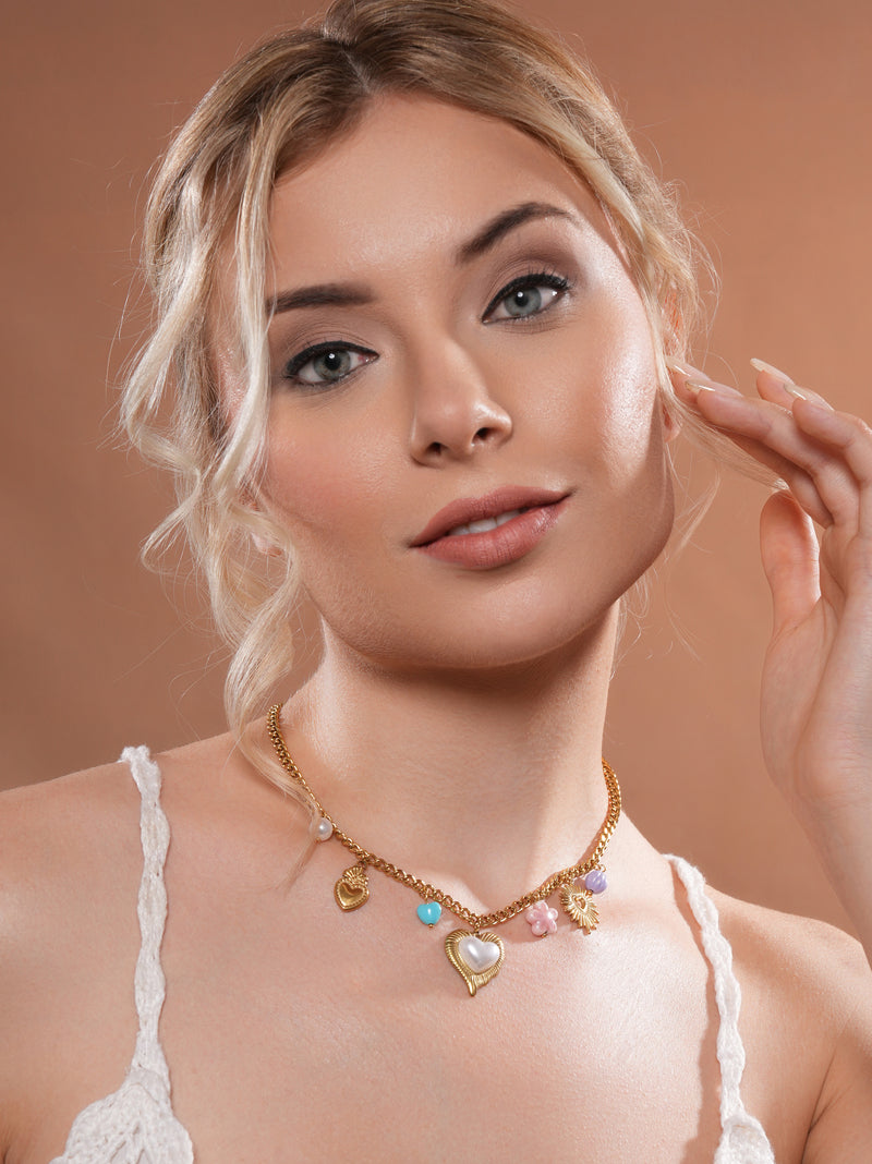 The model exudes charm adorned in the Honeylight Romance Charm Chain by Zelci