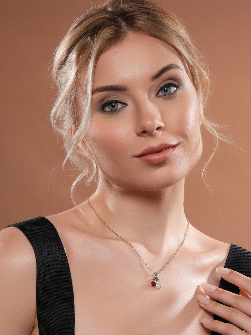 The model is posing with Zelci's Cherry Spark Pendant