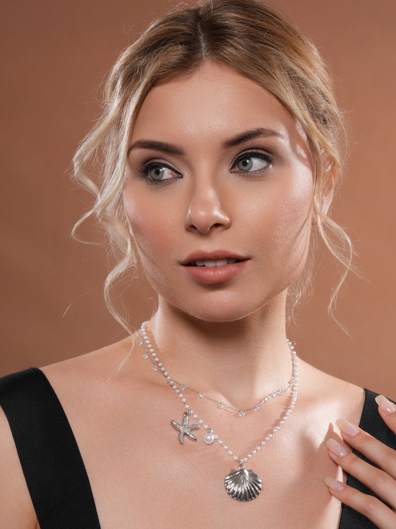 The model is wearing Coastal Layered Necklace in glossy silver colour