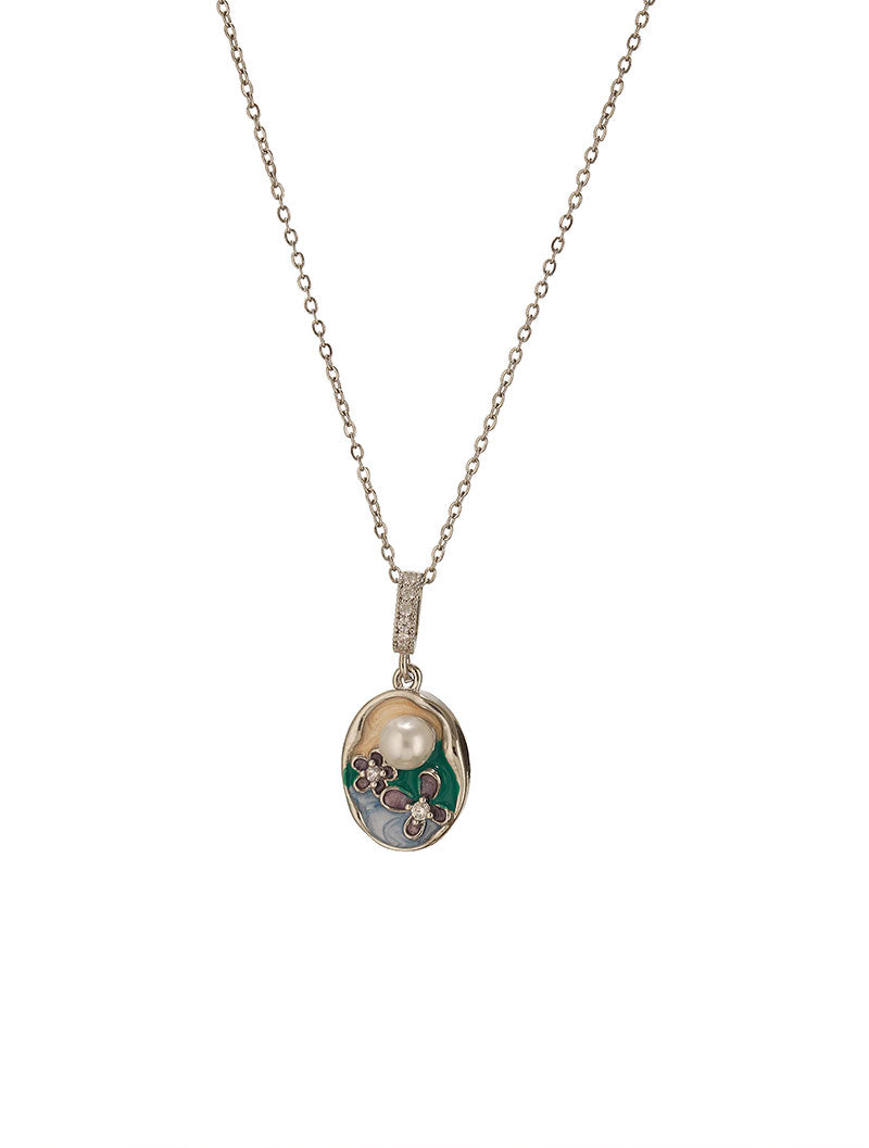 The Pearl Garden Pendant charms on a white background is in the image