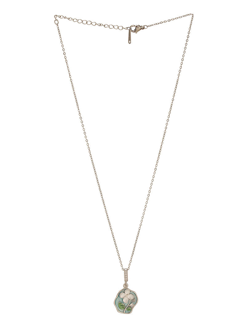 Zelci’s Signature Petaline Pendant rests elegantly on a minimal white backdrop