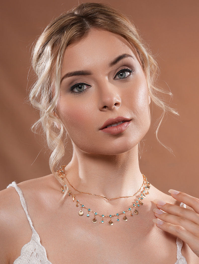 The model exudes confidence while wearing Zelci’s stunning Seaside Layered Necklace