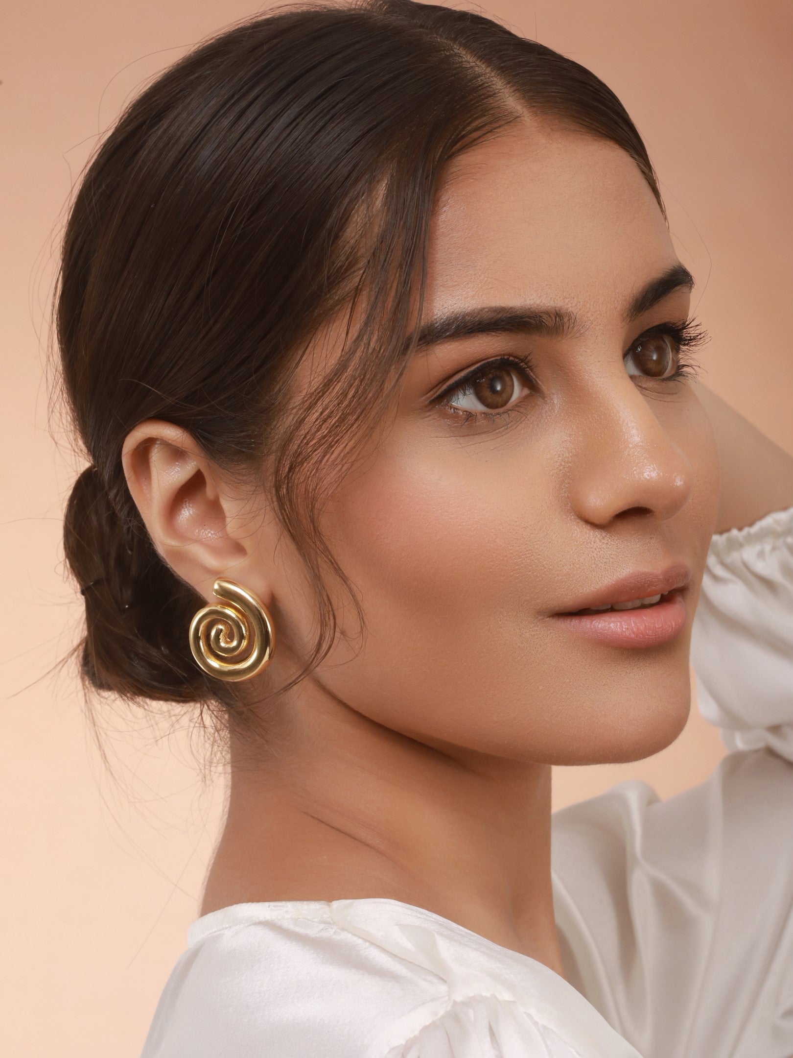 Delicate charm is highlighted with The Swirl Studs of Zelci
