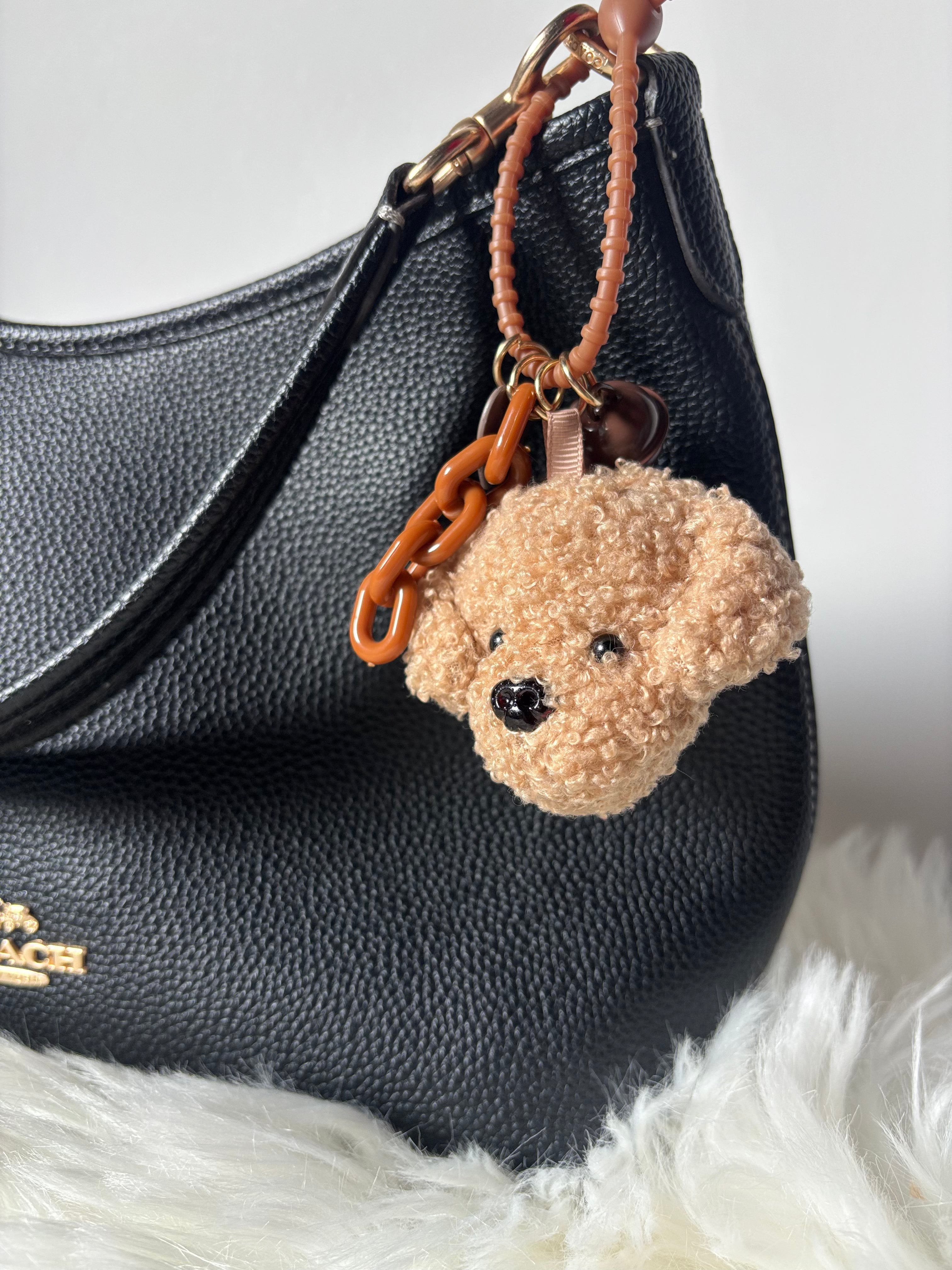 The COACH bag is styled with Zelci’s Plush Keychain on display