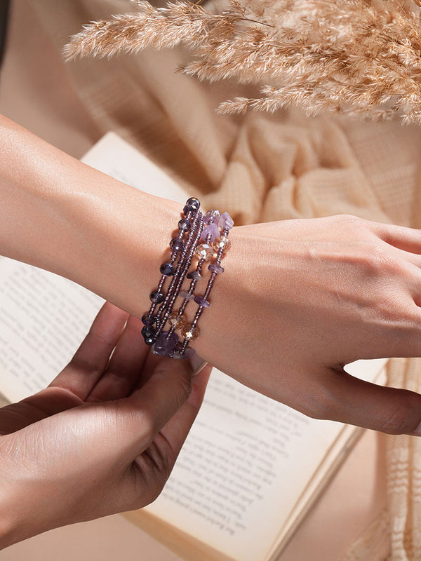 The model radiates charm while posing with Zelci Aurelia Bracelet in her hand