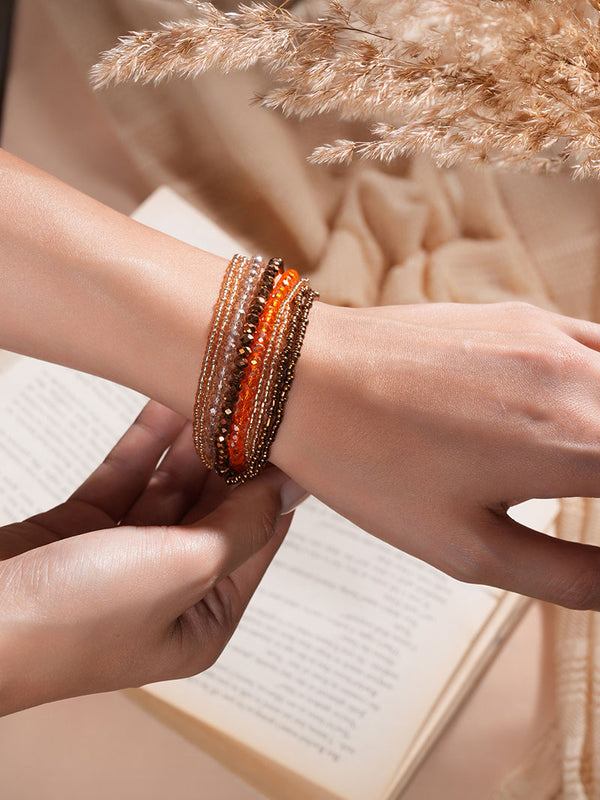 The model exudes elegance while showcasing Zelci Ember Bracelet in her hand.
