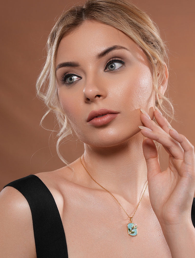 Zelci’s Lilybud Pearl Pendant gleams proudly as the model showcases it.