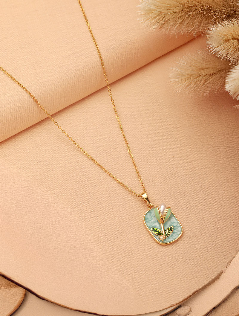 Zelci’s Lilybud Pearl Pendant catches the eye on an artfully styled backdrop.