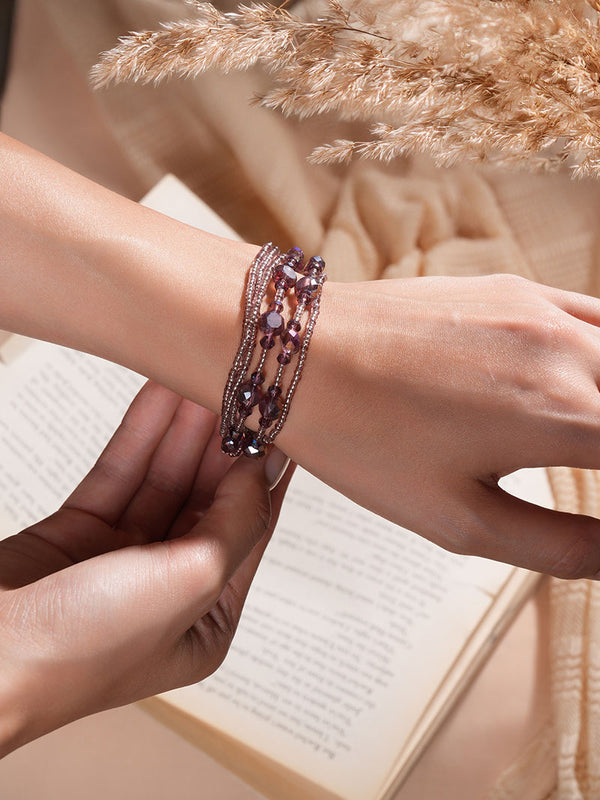 With poise and charm, the model presents Zelci Roselle Bracelet in her hand