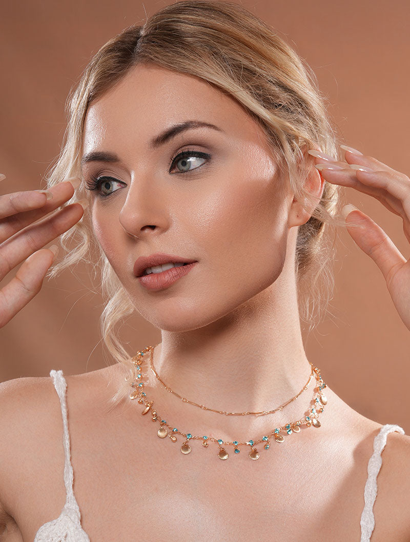 Zelci’s Seaside Layered Necklace gleams proudly as the model showcases it