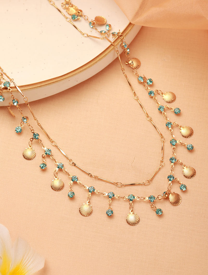 Zelci's Seaside Layered Necklace is beautifully displayed against a decorative backdrop